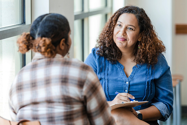 counselor talking to student with clipboard