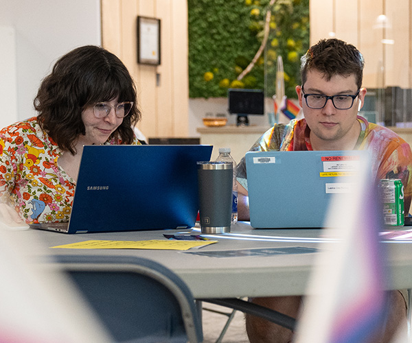 two students sitting at desk on laptops