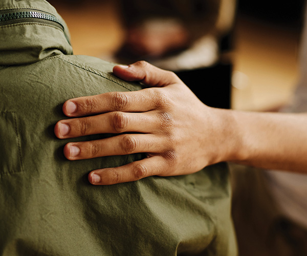 close up of hand on someone's back