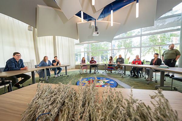 wide view of classroom with students and sage in front