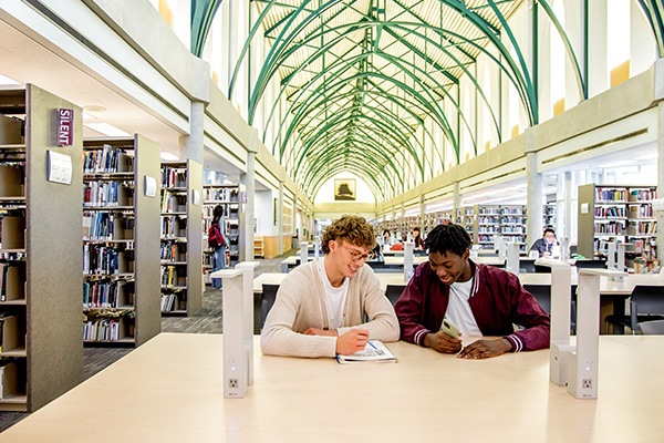 two students studying in the library