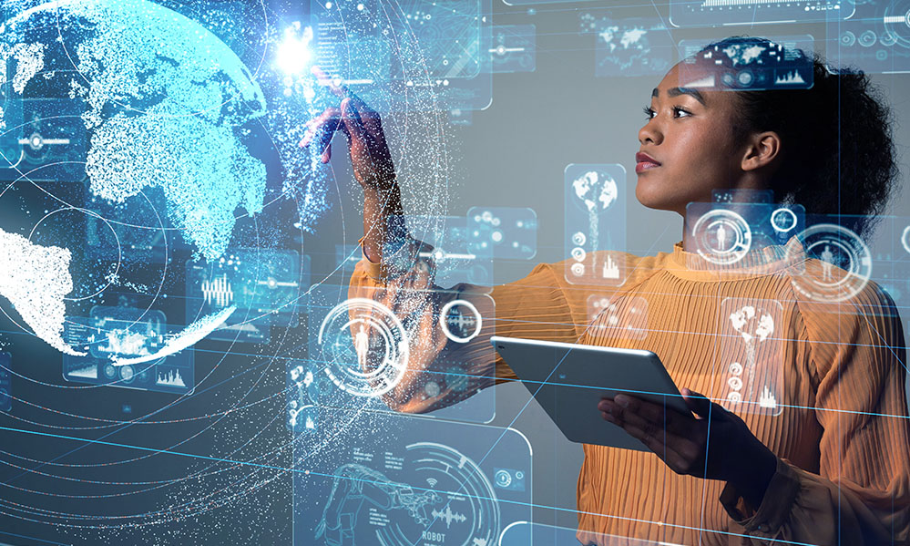 Stock image of a woman standing in front of a transparent computer screen holding an ipad