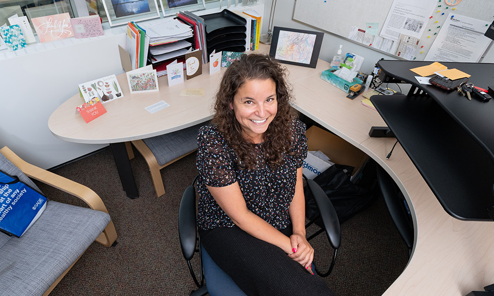 Amanda Nelund sits at her desk