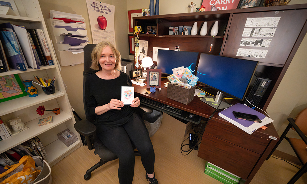 Lori Harper sits at her desk