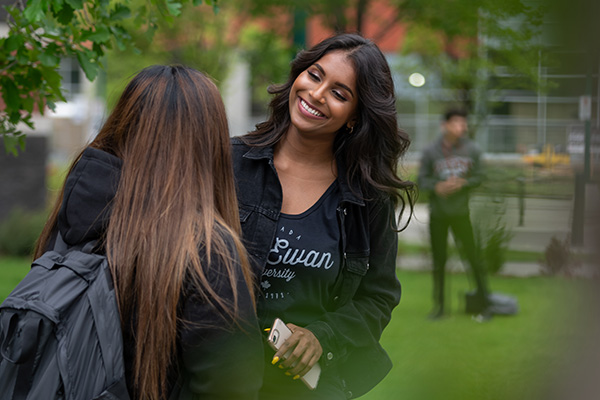 two female students standing outside talking