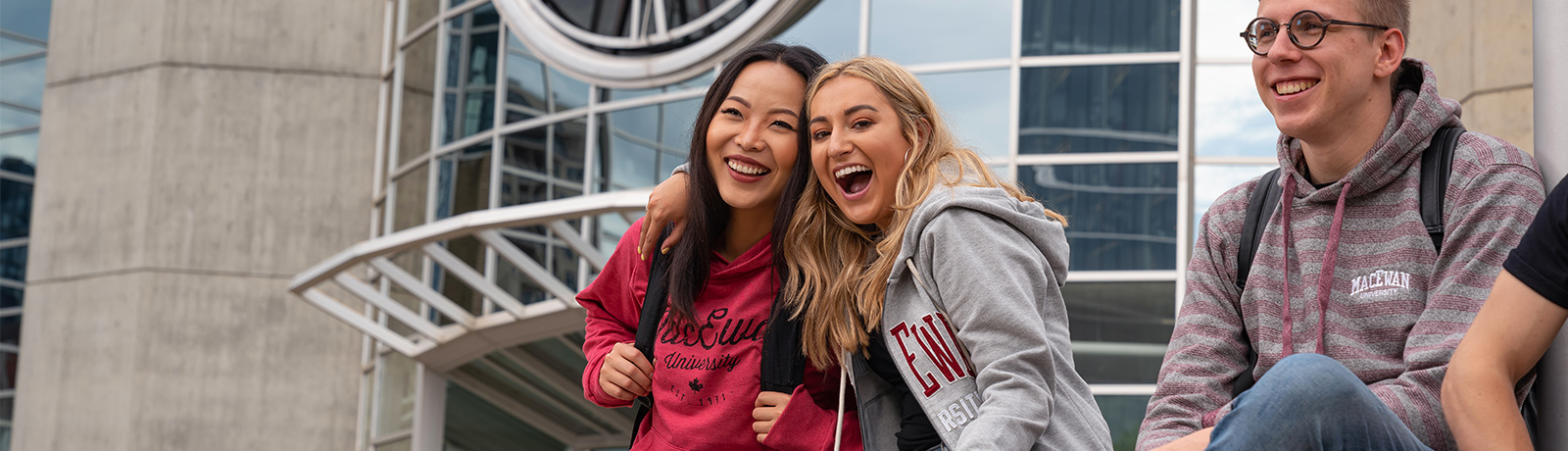 students smiling in front of macewan