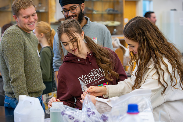 MacEwan volunteers showing potential students their workspace