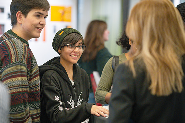 two students talking to an advisor