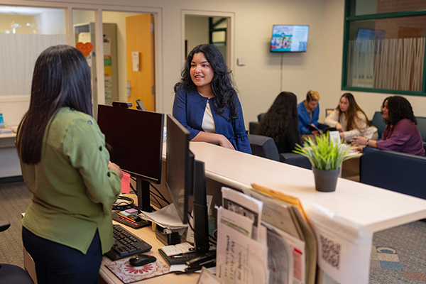 female student at the front desk of Career Services