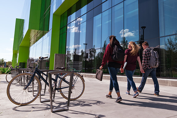 three students walking outside of Allard Hall
