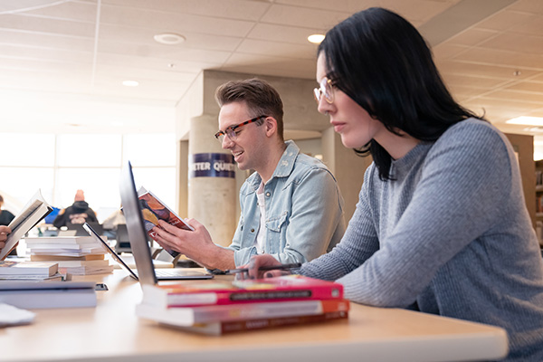 two students studying in the library