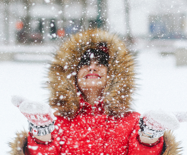 Female student playing in the snow