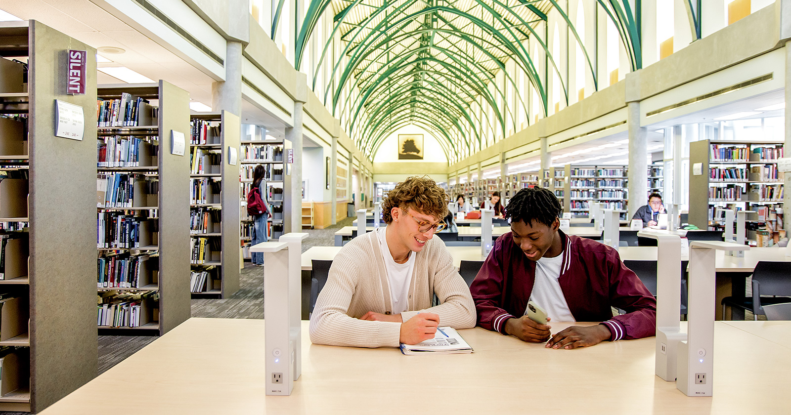 female student standing outside against pillar