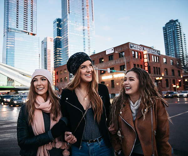three young women walking downtown Edmonton