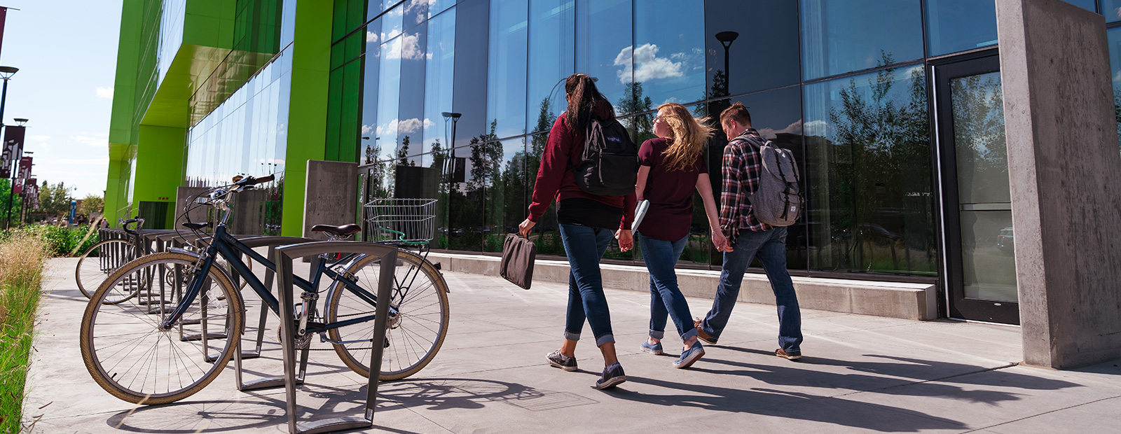 central staircase at MacEwan with blurred images of people walking