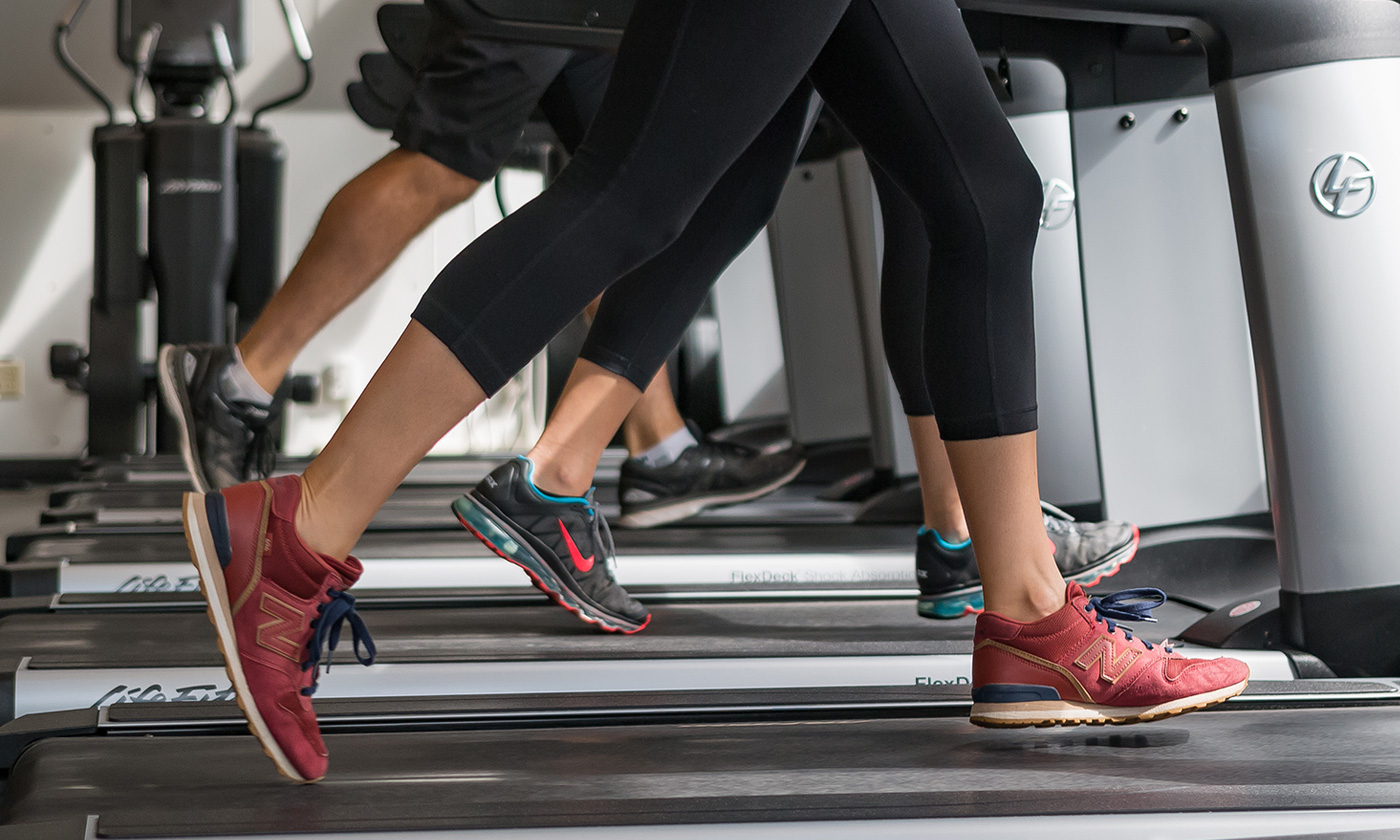 close up of people running on treadmills